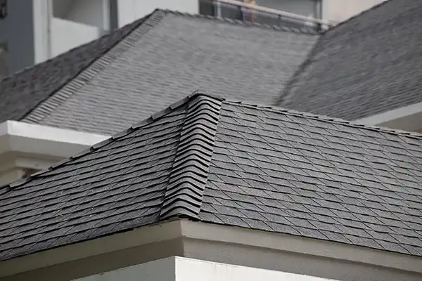 Large residential roof with gray asphalt shingles